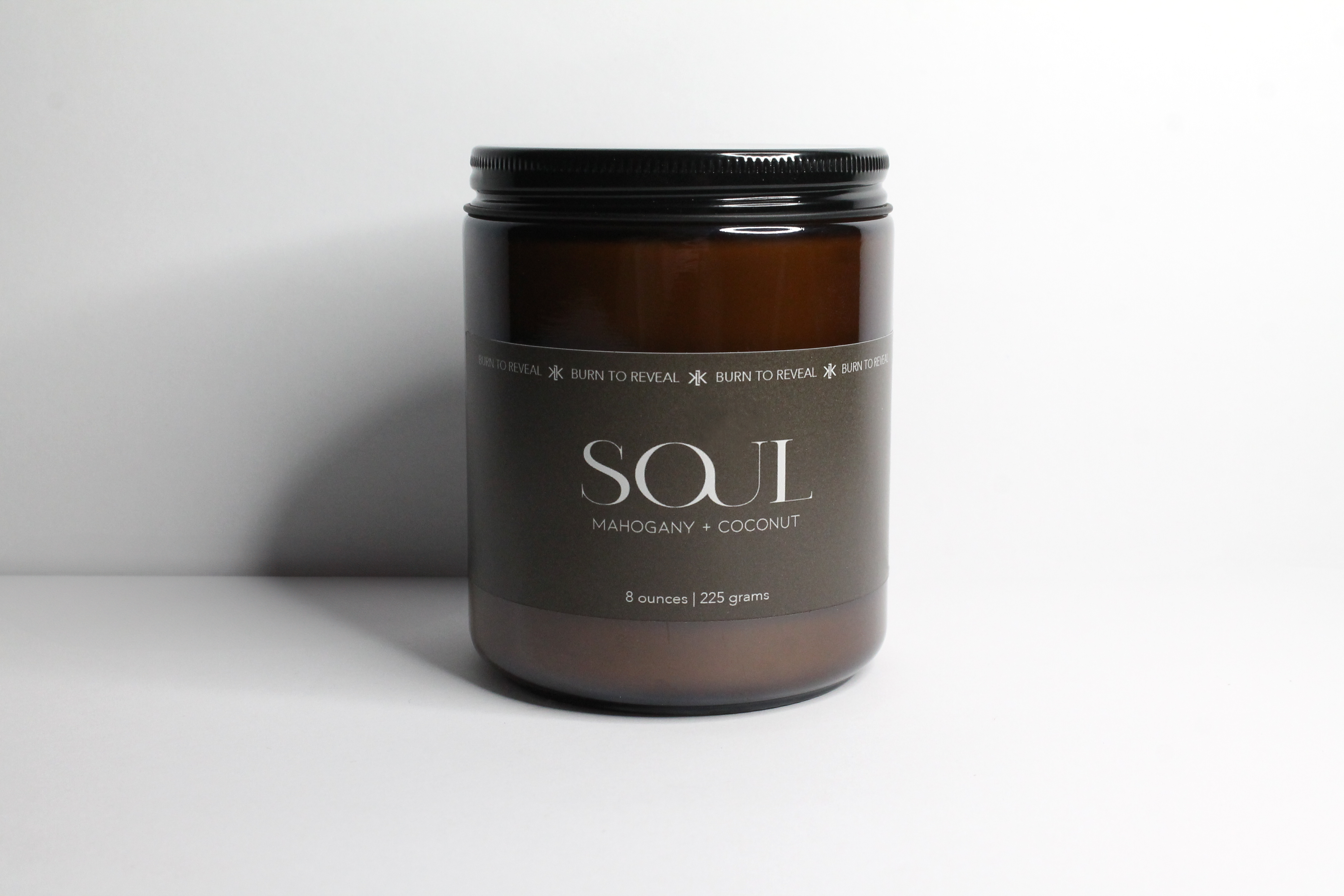 Mahogany and coconut scented soy candle in a 8 ounce amber glass jar.