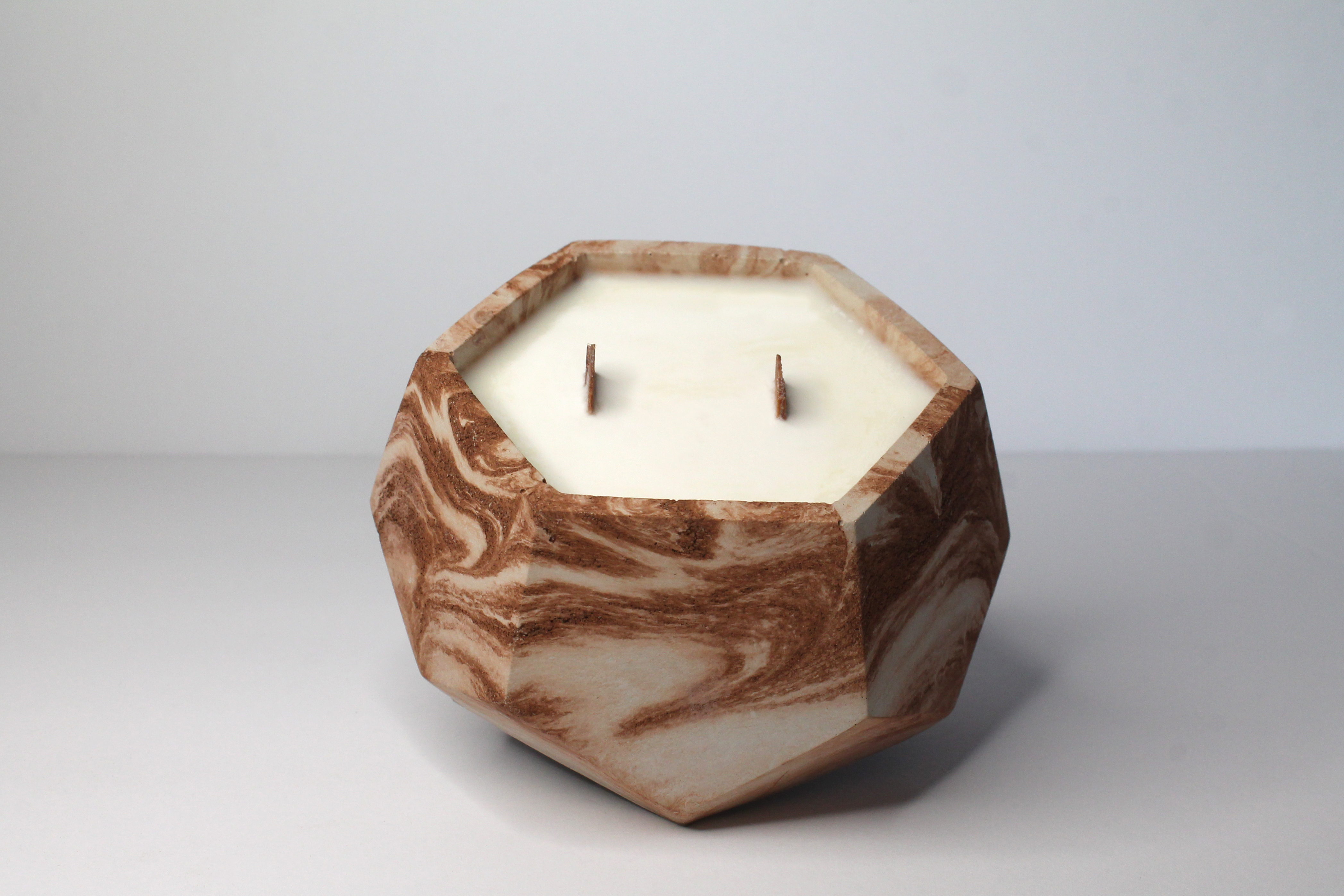 Our candle vessel is copper marble concrete. Made with a double wooden wick.