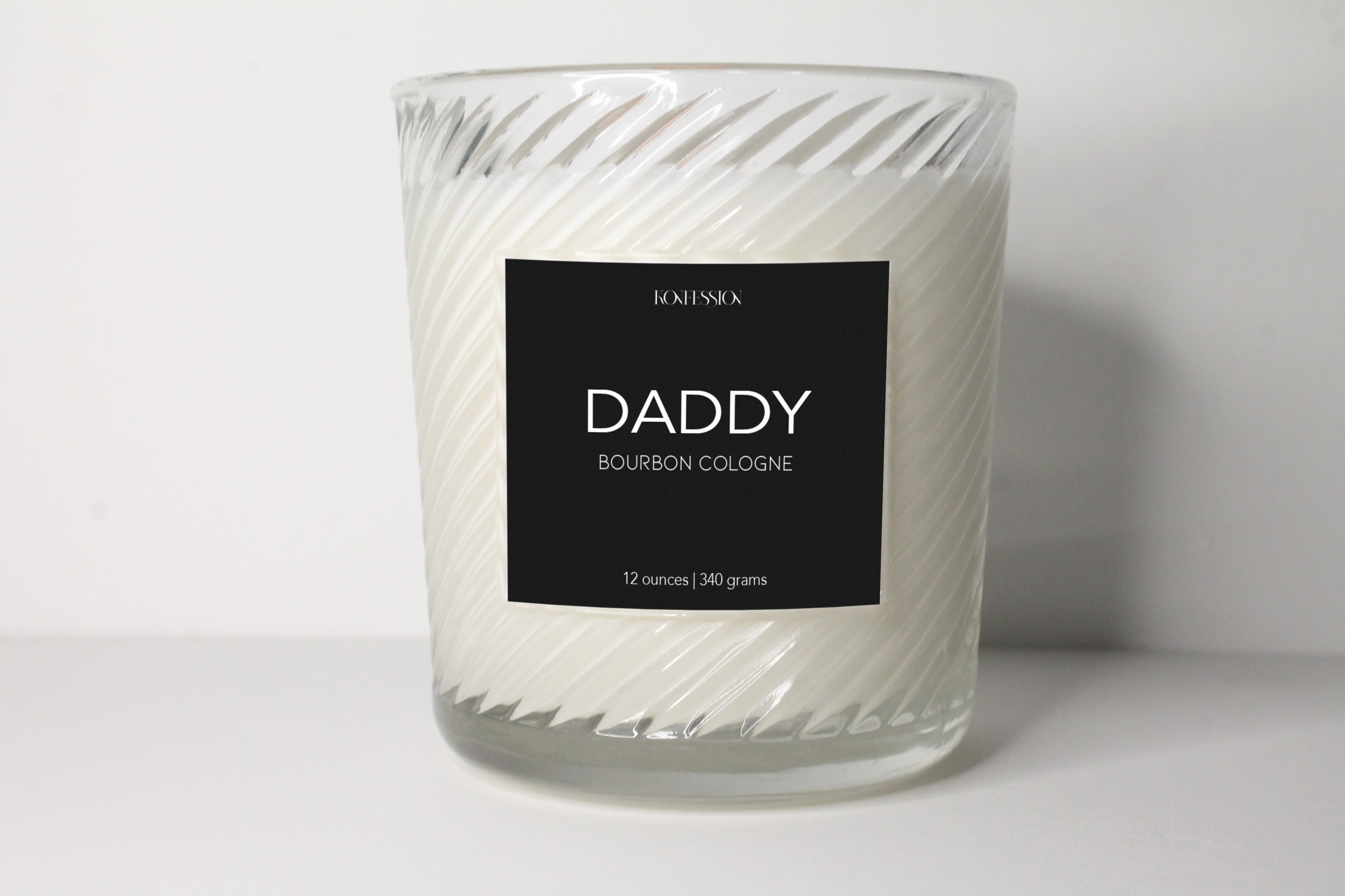 Made with 100% natural soy wax. The candle is packaged in a clear ribbed glass vessel with a black lable and white writing.