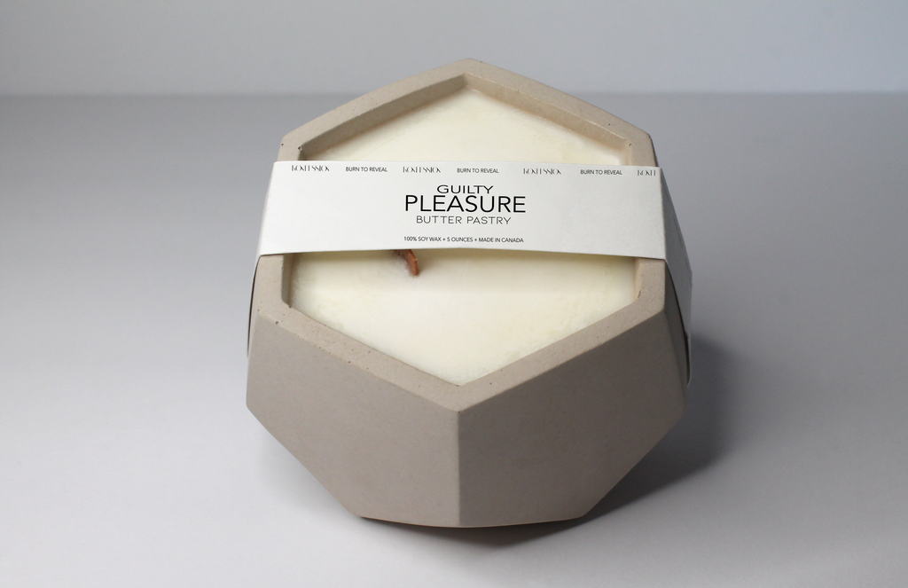 Beige concrete soy wax candle in the scent of butter pastry.