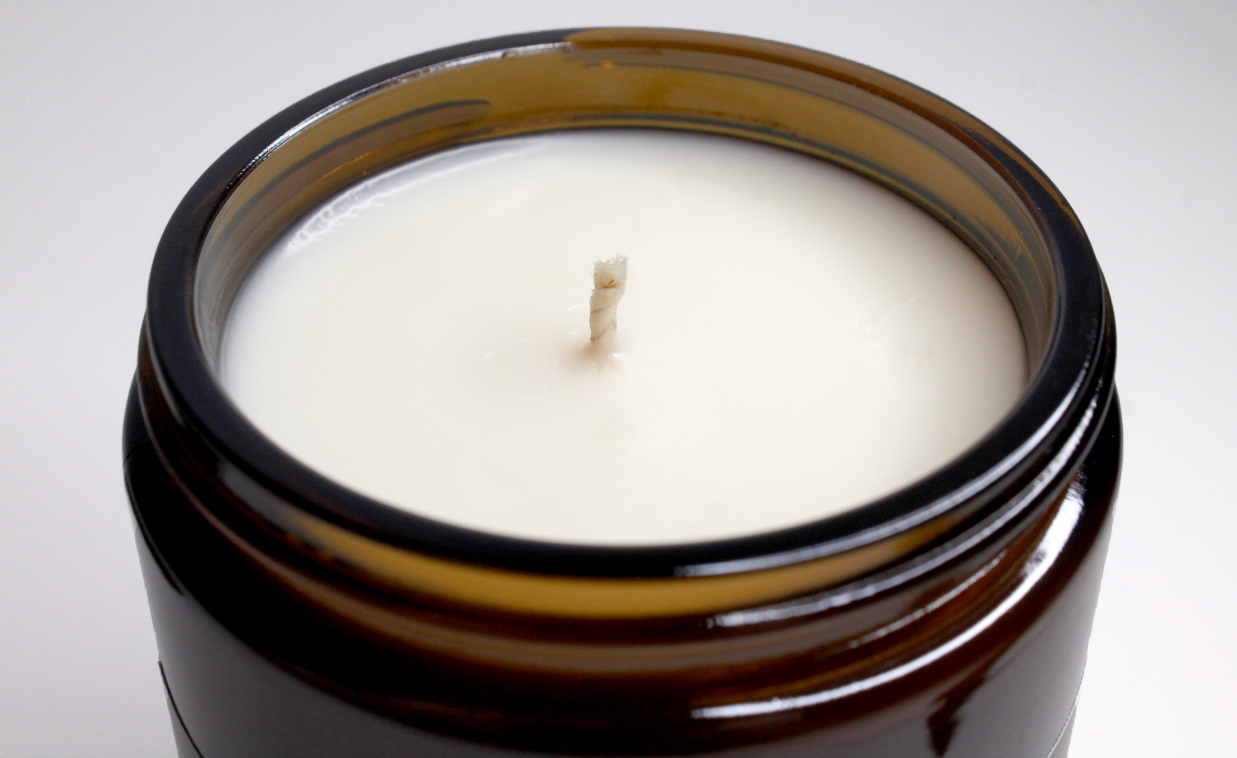 8 ounce cotton wick candle in the scent of mahogany and coconut. In an 8 ounce amber glass jar.