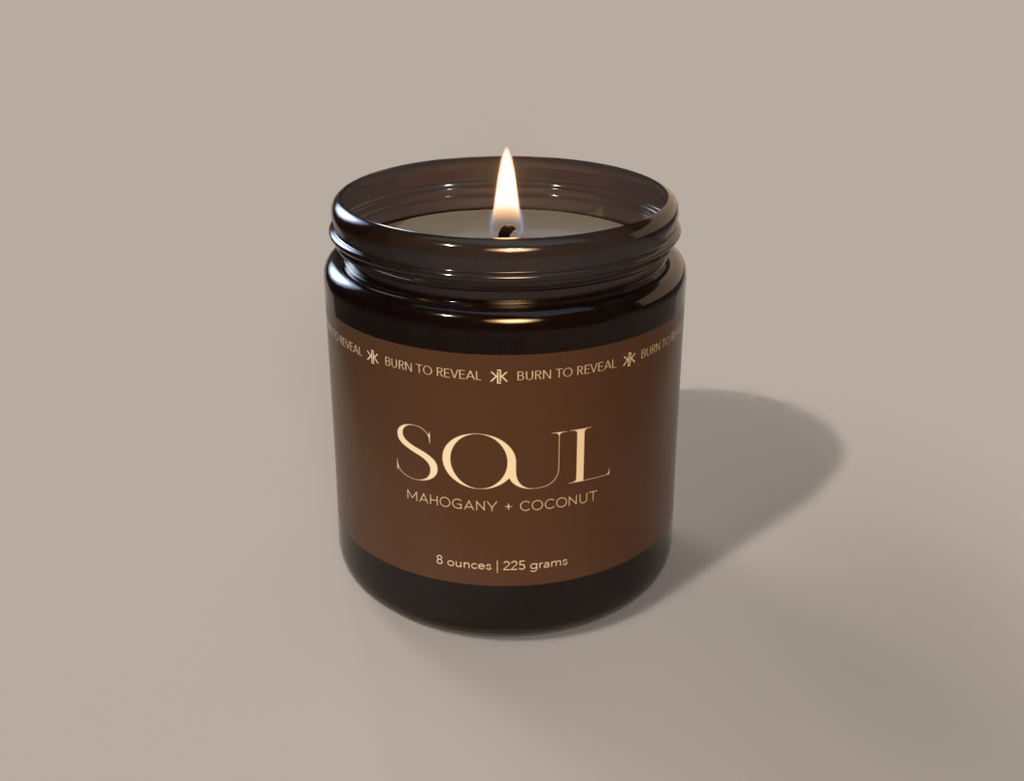 8 ounce candle called "Soul" in the scent of mahogany and coconut. The single wick candle is contained in a amber glass jar with a black metal lid.