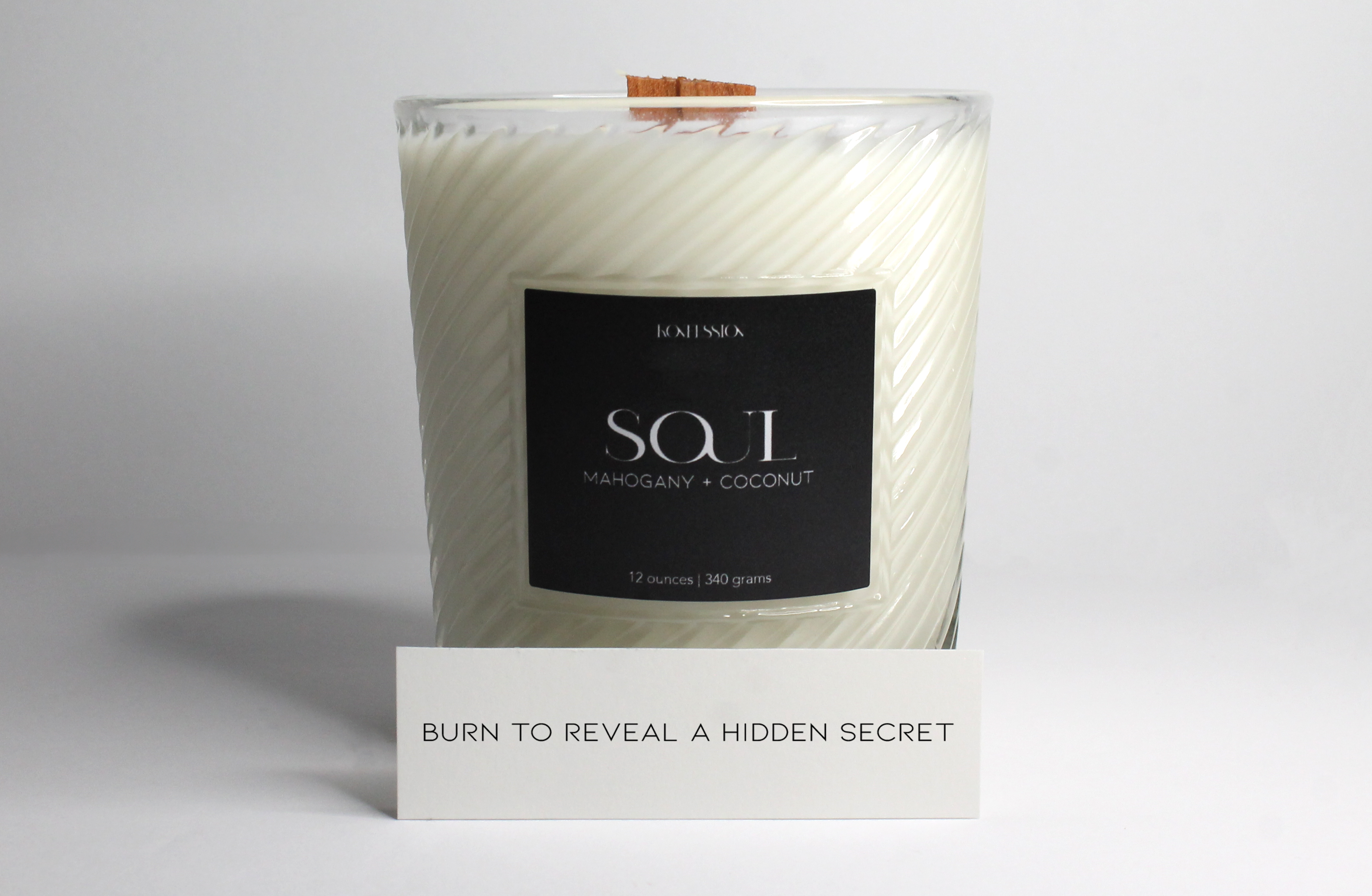 burn to reveal 12 ounce soy candle in the scent of mahogany and coconut.