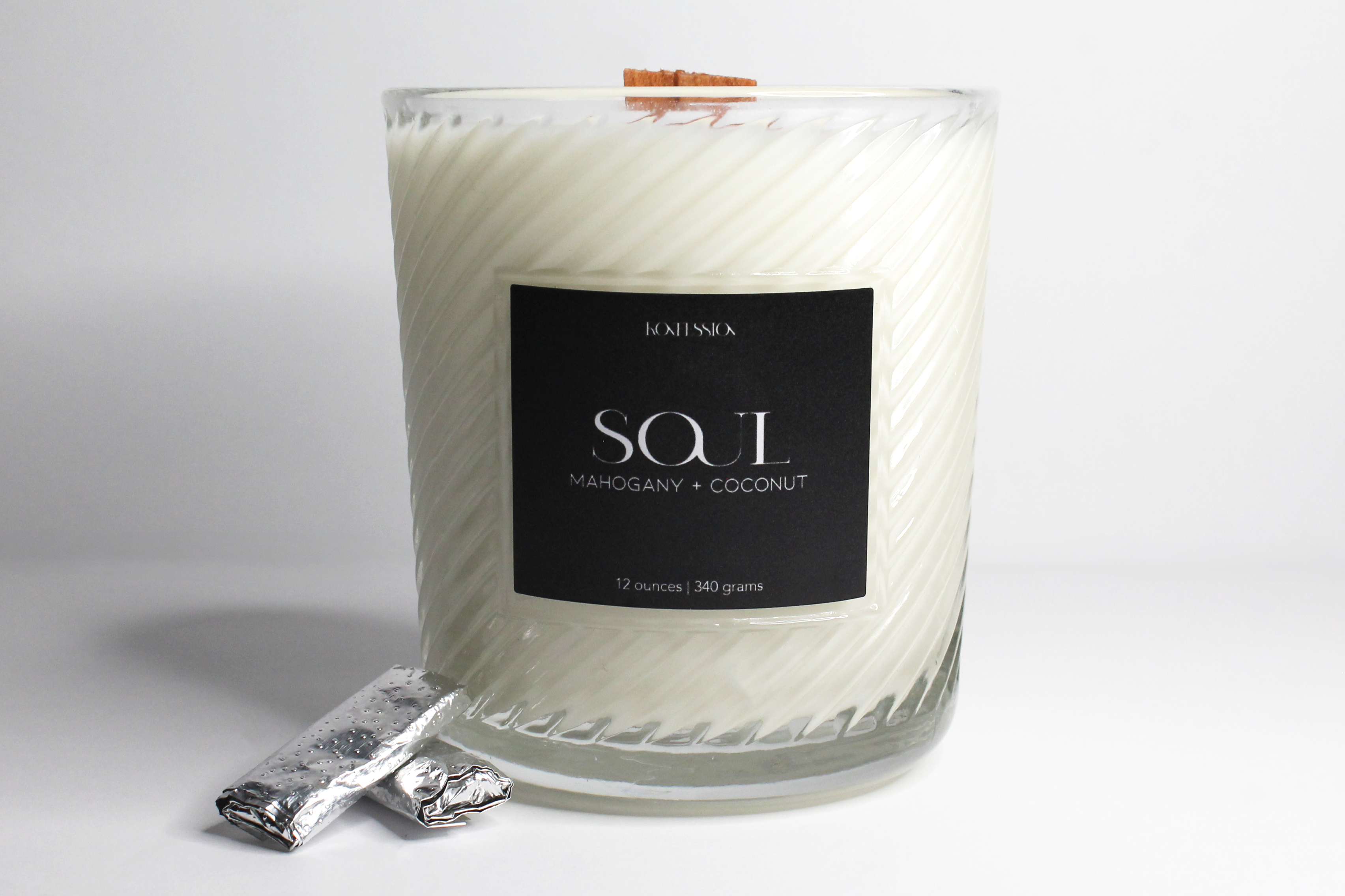 12 ounce soy wax candle in the scent of mahogany and coconut with a burn to reveal secret hidden inside.
